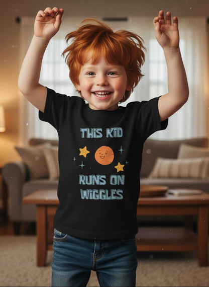 Black t-shirt with space-themed design and text on young boy with red hair dancing in his home