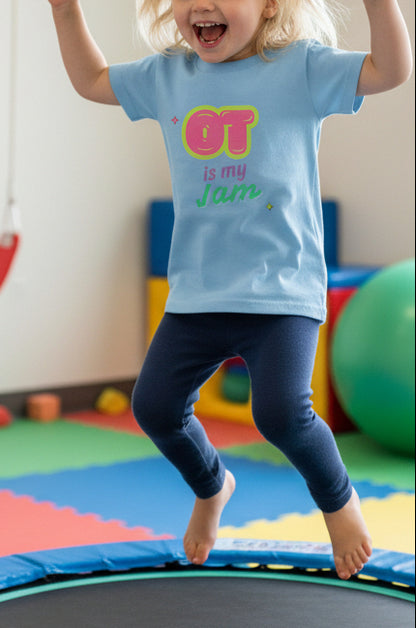 Light blue t-shirt with 'OT is my Jam' text design on a little blond girl while she's jumping on a trampoline