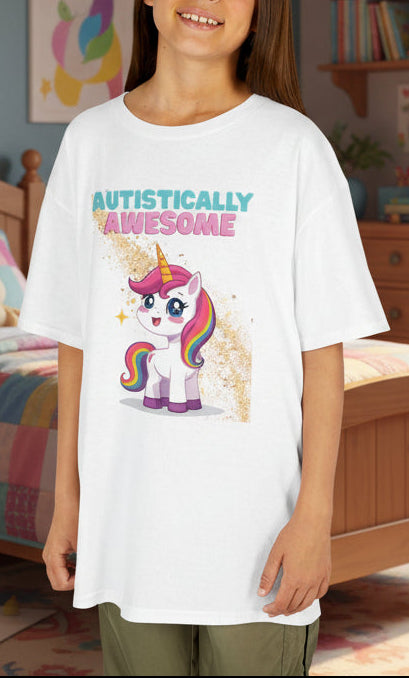 Child wearing a 'Autistically Awesome' t-shirt with a unicorn design in a bedroom.