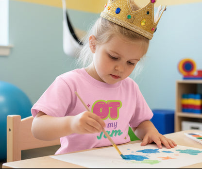 Pink t-shirt with 'OT is my Jam' text on a young girl painting and wearing a crown