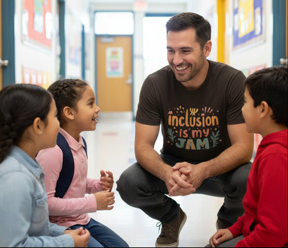 Brown t-shirt with 'Inclusion is my JAM' text and design with a male teacher speaking to young students in a school hallway